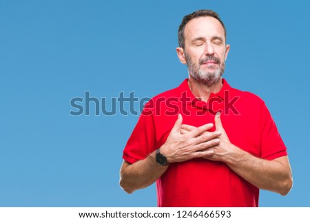 Middle age hoary senior man over isolated background smiling with hands on chest with closed eyes and grateful gesture on face. Health concept.