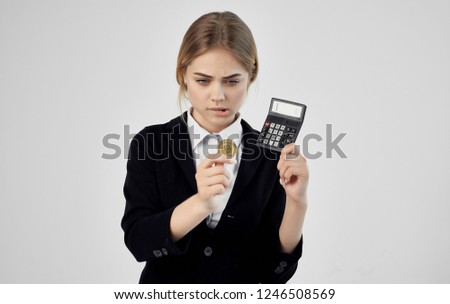 Woman with Bitcoin cryptocurrency calculator in hand                   