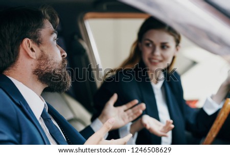 A man and a woman are sitting in a car                    