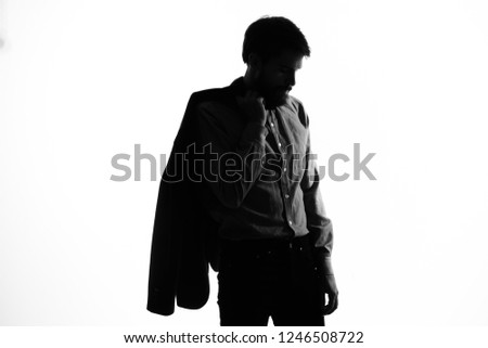 Handsome man with a jacket on his shoulder in the shade               