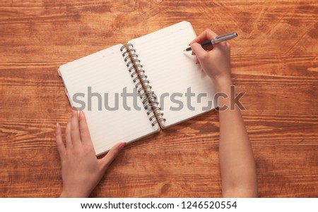 girl writes in a notebook