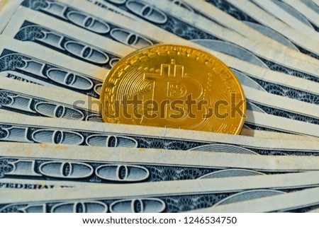 Golden bitcoin coins on a paper dollars