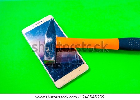 Hammer Smashing Smart Phone on a green background