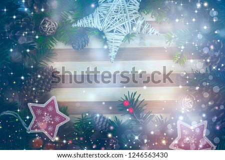 Christmas background with decorations and pine cones, on wooden board