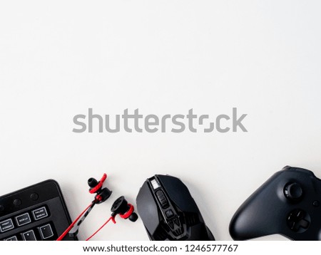 top view of gaming gear with mouse, keyboard, joystick, headphone on white table background with copy space. 