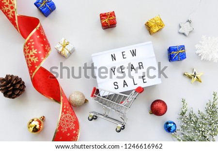 new year SALE text on lightbox composition and Christmas decorations