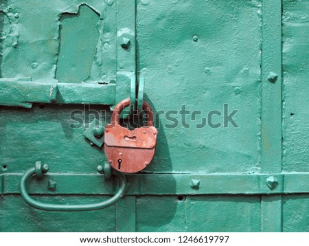 Durable wrought iron door and vintage padlock of an old orthodox church in Uglich