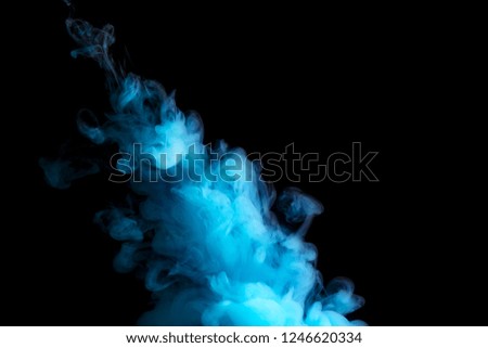 paint stream in water, blue colored ink cloud on black background, abstract background