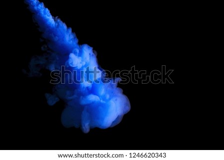 paint stream in water, blue colored ink cloud on black background, abstract background