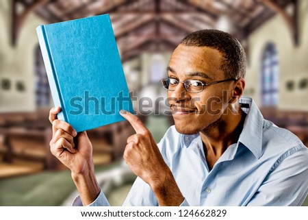 Nerdy looking black african american holding a book