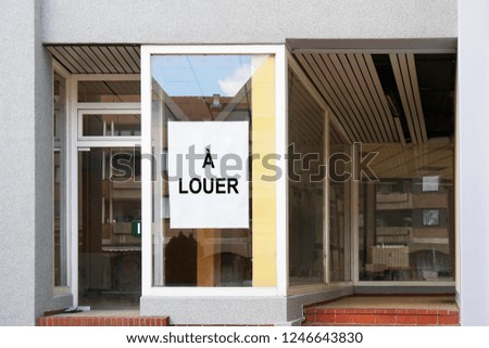french vacancy sign in shop or store window reads a louer which translates as for rent