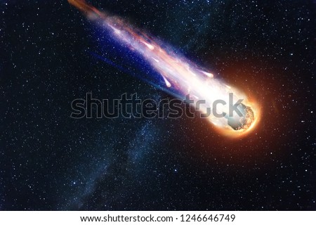 A comet, an asteroid, a meteorite falls to the ground against a starry sky. Attack of the meteorite. Meteor Rain. Kameta tail. End of the world. Astranomy. Royalty-Free Stock Photo #1246646749