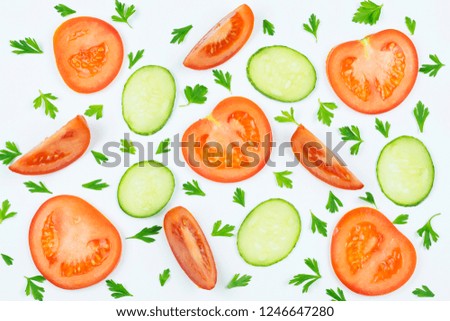 Background: tomato and cucumber Slices, parsley leaves on white background. The concept of cooking. Culinary theme.