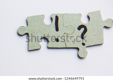 question mark and exclamation mark on a puzzle, heap on a colored background, the concept of confusion, the question or solution