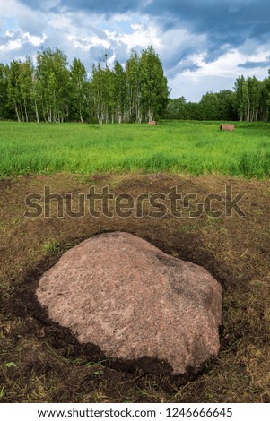 large granite rock single in nature environment isolated from other