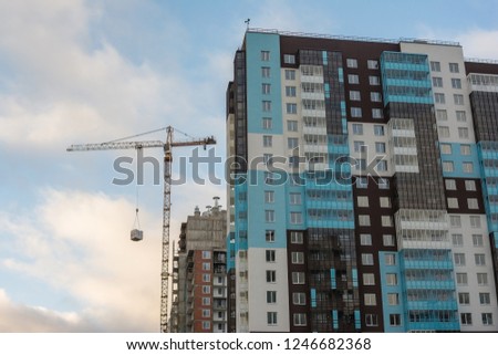 industrial construction tower crane and a new modern and stylish and beautiful multistorey residental house