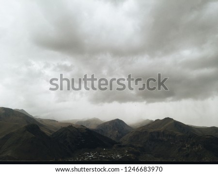 Kazbek mount in rainy clouds and fog. Georgia