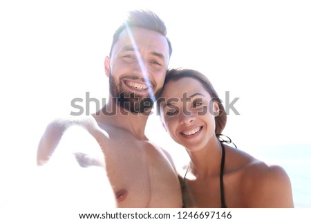 Happy couple spending carefree time on the beach outdoors.