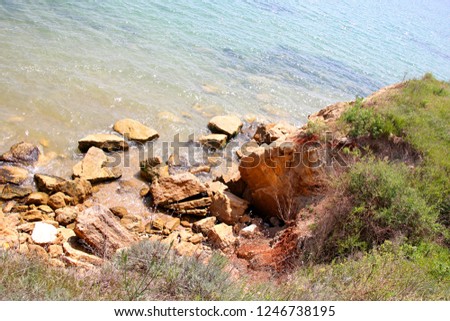 Beautiful wild Beach Fontanka near Odessa. Yellow and red sandstone cliffs are located on the seafront. Sunny day