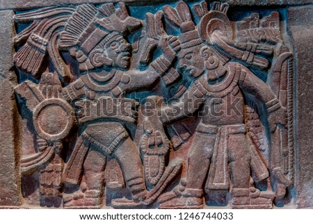 rock wall with engravings of Aztec gods Royalty-Free Stock Photo #1246744033