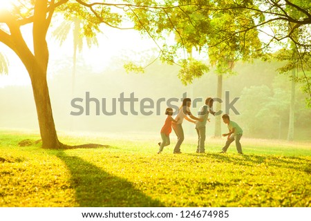 Asian family outdoor quality time enjoyment, asian people playing during beautiful sunrise Royalty-Free Stock Photo #124674985