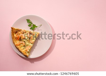 Homemade quiche of vegetables and prawns. Top lay. Top view on pink background