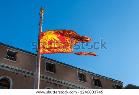 Venetian flag flying on flag pole