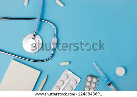 Medical concept blue background. Doctor's desk with instruments. Copy space.
