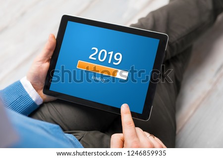 Conceptual image of man looking at tablet and getting ready for New Year.