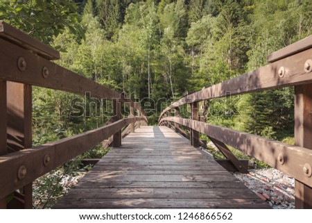 wood bridge crossing a river in the swiss alps, no people, picture from below