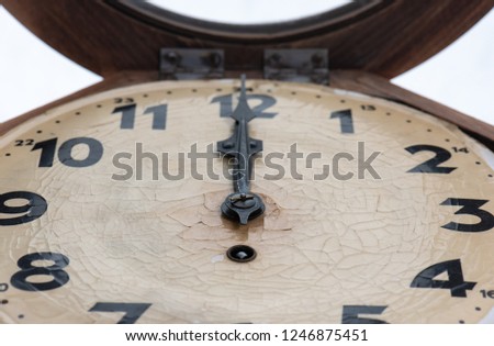 Close up of an approximately 100 year old clock with a crackled surface (low depth of field). Indicated time is 12 o'clock