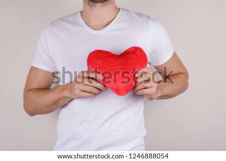 Passion life health healthy support help relief couple concept. Cropped close up photo studio portrait of handsome gentle macho gentleman holding big heart isolated grey background