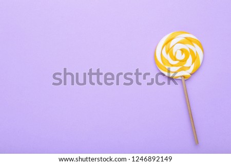 Colorful lollipop on purple background