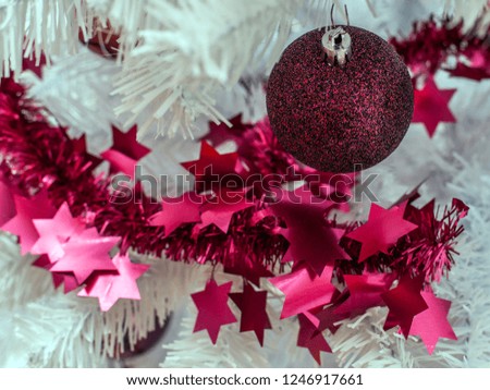 Picture shows a Christmas bauble on a white tree