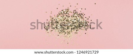 New Year or Christmas abstract Top view of golden stars confetti with copy space millennial pink color paper background minimal style. Template for feminine blog social media