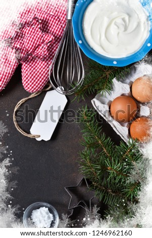 Ingredients for baking. Christmas card with decorations on concrete background. Christmas baking, cooking process.