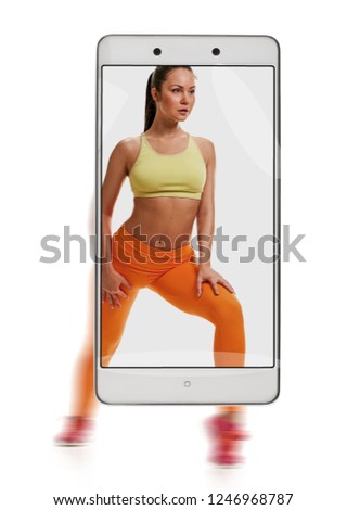 Young sporty woman doing squat fitness exercises. conceptual image with a smartphone, demonstration of device capabilities
