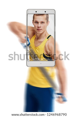 Photo of concentrated young sporty man working out with expander. conceptual image with a smartphone, demonstration of device capabilities