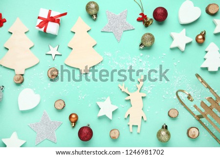 Christmas decorations with wooden fir trees and deer on mint background
