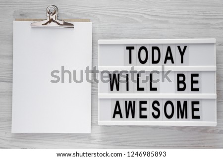 'Today will be awesome' words on modern board, noticepad over white wooden background, overhead view. Top view, flat lay, from above.
