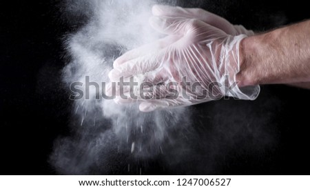 Chef Hands Clapping With Flour In Slow Motion on black background. Frame. Chef Claps Hands Together With Flour, Super Slow Motion