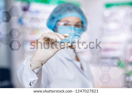 A laboratory assistant is organizing the digital system consisted of different medical and lab symbols and icons at the touchscreen. The concept is the innovative means of lab research.