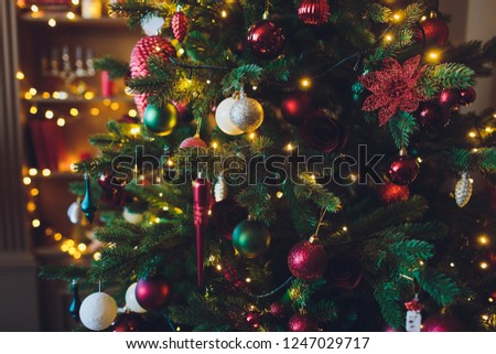 Christmas background - baubles and branch of spruce tree.