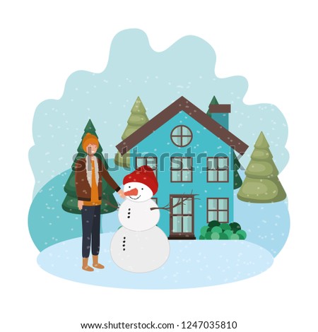 man with snowman and house in winter 