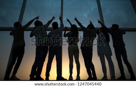 in full growth. business team pointing up Royalty-Free Stock Photo #1247045440