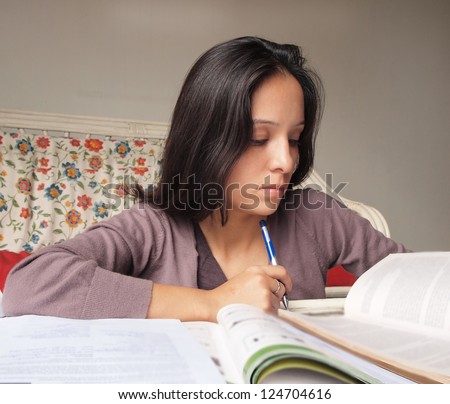 Young Teenager studying at home.