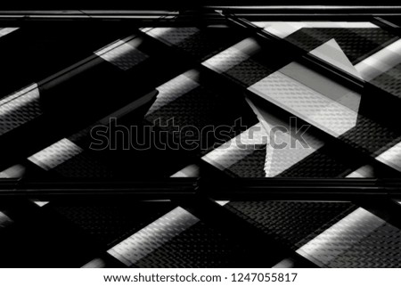 Reworked photo of modern architecture fragment with textured glass panels. Grunge abstract black and white architectural or technological background in hi-tech style.