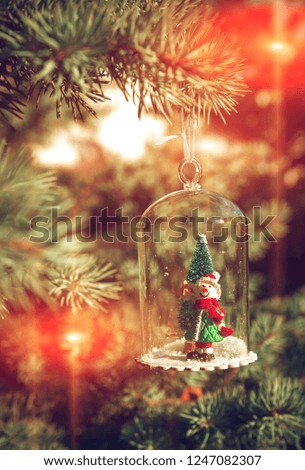 New Year and Christmas snowman at sunset, fabulous picture on a blurred background.
