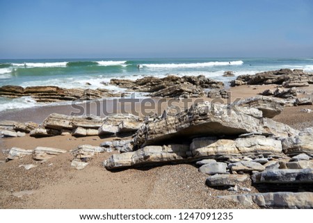 Sharp rocks on the ocean coast. Stones and water