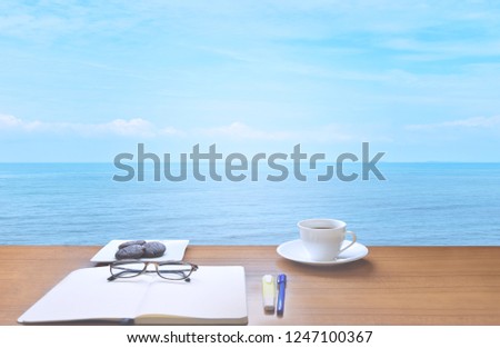 Sea of Sky and Clouds of White Nature with a cup of coffee, chocolate cookies, glasses, diary, notebook, pen and notebook to save memories on holidays in Thailand.